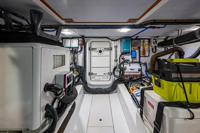 Slide: The Image of Engine room of 2016 Kadey-Krogen 52 yacht, featuring equipment and storage. - 80