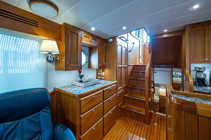 Slide: The Image of Luxurious 2016 Kadey-Krogen 52 yacht interior with wooden cabinetry and elegant staircase. - 9