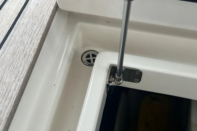 Slide: The Image of Hatch hinge detail on 2016 Kadey-Krogen 52 yacht, showcasing stainless steel hardware. - 90