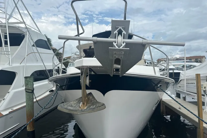 Slide: The Image of 2016 Kadey-Krogen 52 yacht docked at marina, front view with anchor visible. - 93