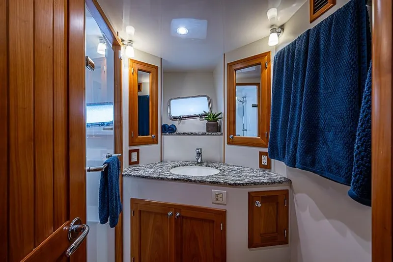 Slide: The Image of Luxurious bathroom in 2016 Kadey-Krogen 52 yacht with granite countertop and wooden cabinetry. - 29