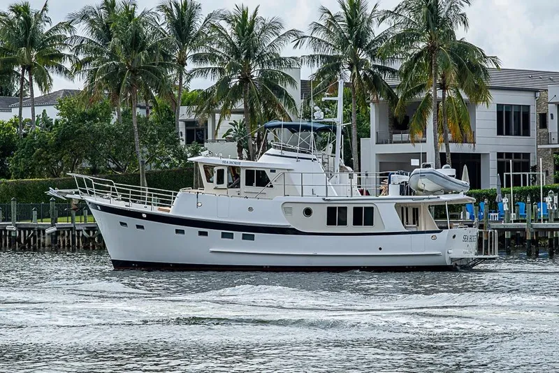 Slide: The Image of 2016 Kadey-Krogen 52 yacht cruising near waterfront homes with palm trees. - 4