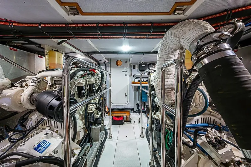 Slide: The Image of Engine room of 2016 Kadey-Krogen 52 yacht, featuring advanced mechanical systems and piping. - 77