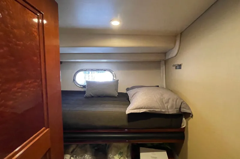 Slide: The Image of Luxurious 2006 Marquis 59 yacht bathroom with elegant wood finishes and modern amenities. - 12