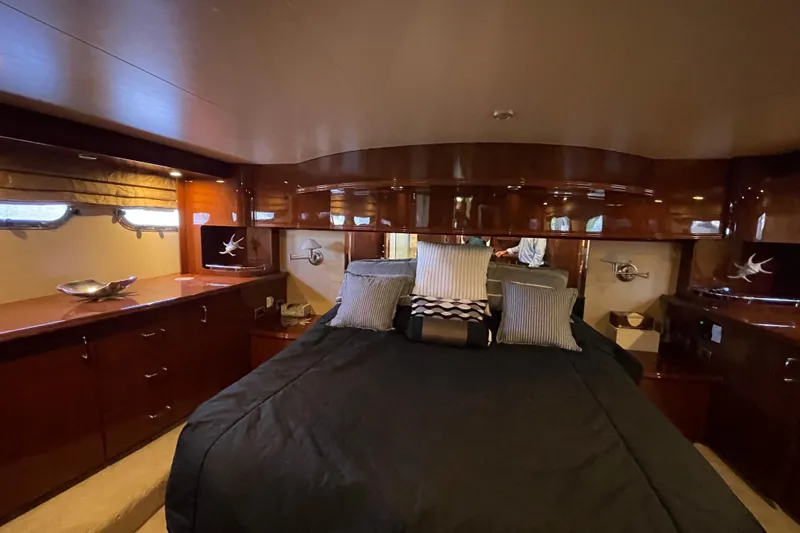 Slide: The Image of Luxurious 2006 Marquis 59 yacht bedroom with elegant wood finishes and modern amenities. - 14