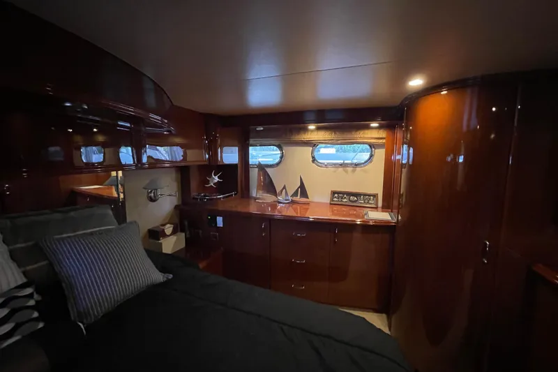Slide: The Image of Luxurious 2006 Marquis 59 yacht bedroom with elegant wood finishes and modern amenities. - 15