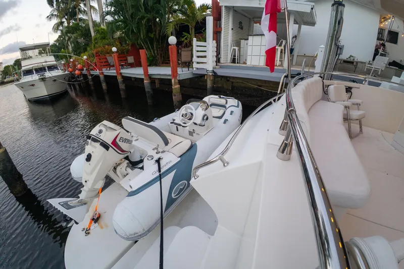 Slide: The Image of Luxury yacht Marquis 59 (2006) docked with inflatable boat and Canadian flag. - 2