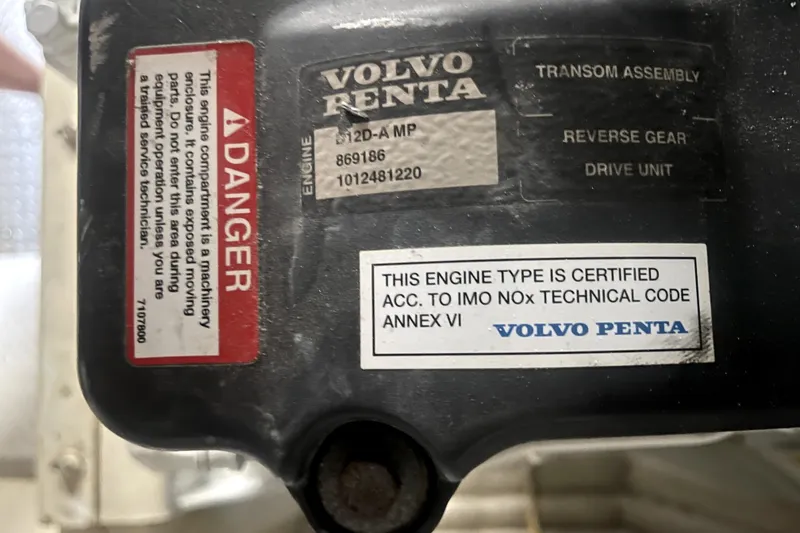Slide: The Image of Engine compartment with Volvo Penta certification and safety warning labels, Marquis 59, 2006 model. - 24