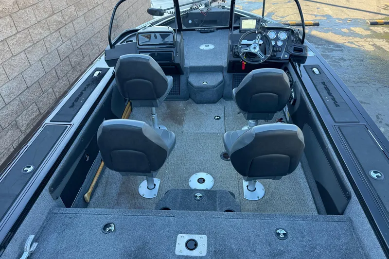 Slide: The Image of 2023 Tracker Targa V-19 WT boat interior with four seats and control panel. - 12