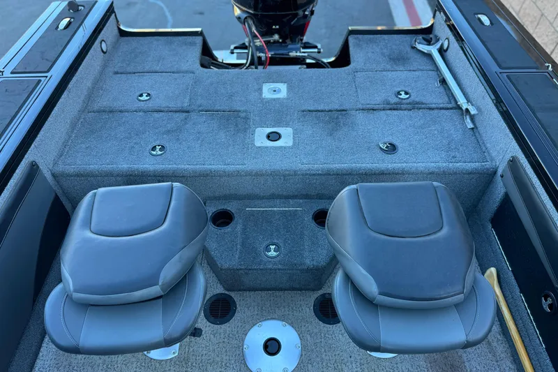 Slide: The Image of 2023 Tracker Targa V-19 WT boat interior with two seats and storage compartments. - 15