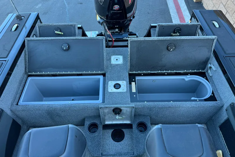 Slide: The Image of 2023 Tracker Targa V-19 WT boat interior with open storage compartments and seating. - 16