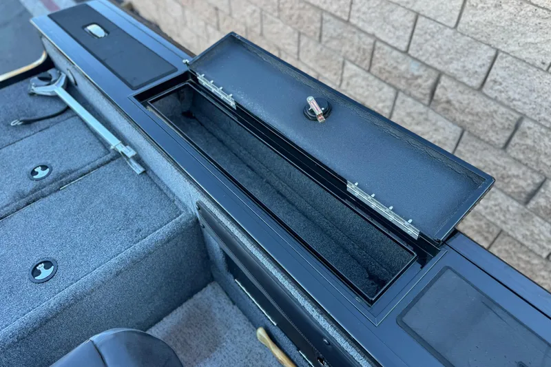 Slide: The Image of 2023 Tracker Targa V-19 WT boat storage compartment with open lid, showcasing interior details. - 18