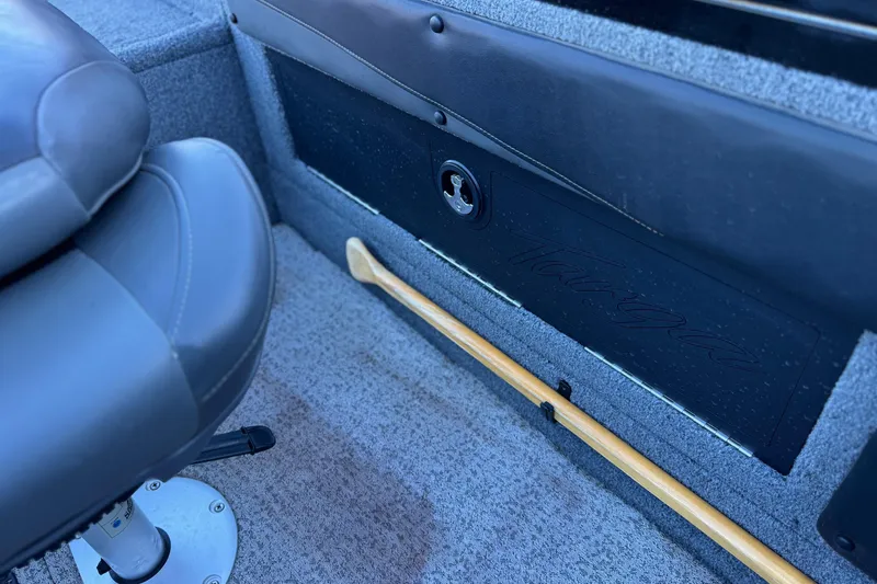 Slide: The Image of 2023 Tracker Targa V-19 WT interior with seat and storage compartment. - 19