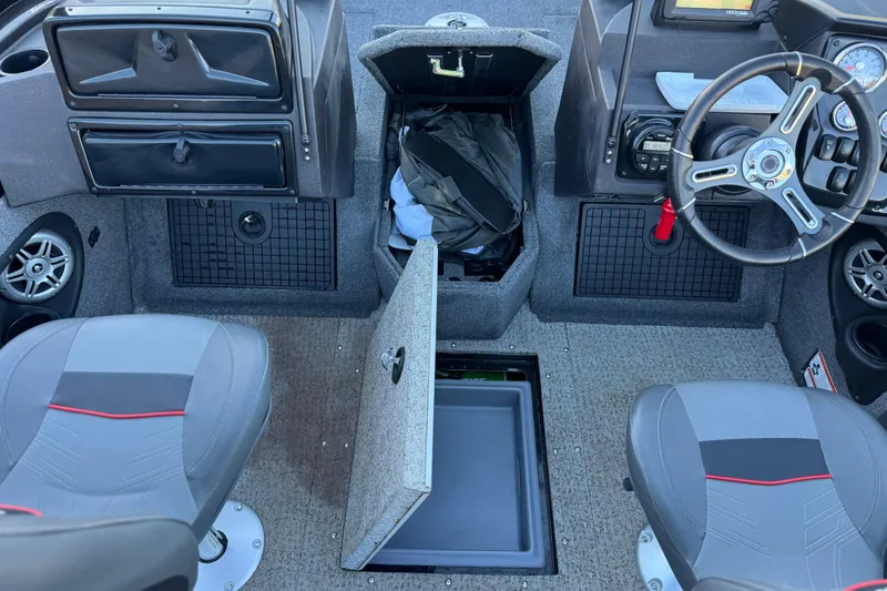 Slide: The Image of 2023 Tracker Targa V-19 WT boat interior with storage compartments and steering wheel. - 21