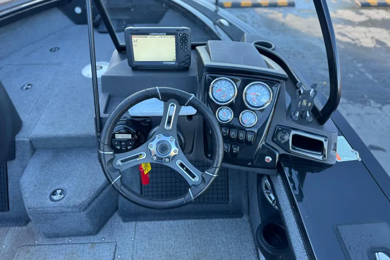 Slide: The Image of 2023 Tracker Targa V-19 WT boat dashboard with steering wheel and gauges. - 26