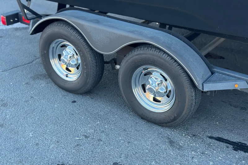 Slide: The Image of Trailer wheels of 2023 Tracker Targa V-19 WT on pavement. - 30