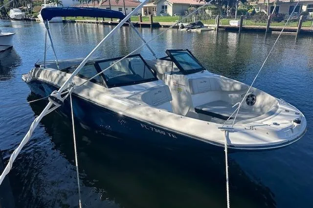 The Image of 2022 Sea Ray SPX 210 boat docked on a sunny waterfront. - 0