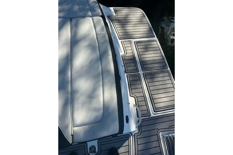 Slide: The Image of 2022 Sea Ray SPX 210 boat deck with cushioned seating and sleek design. - 14