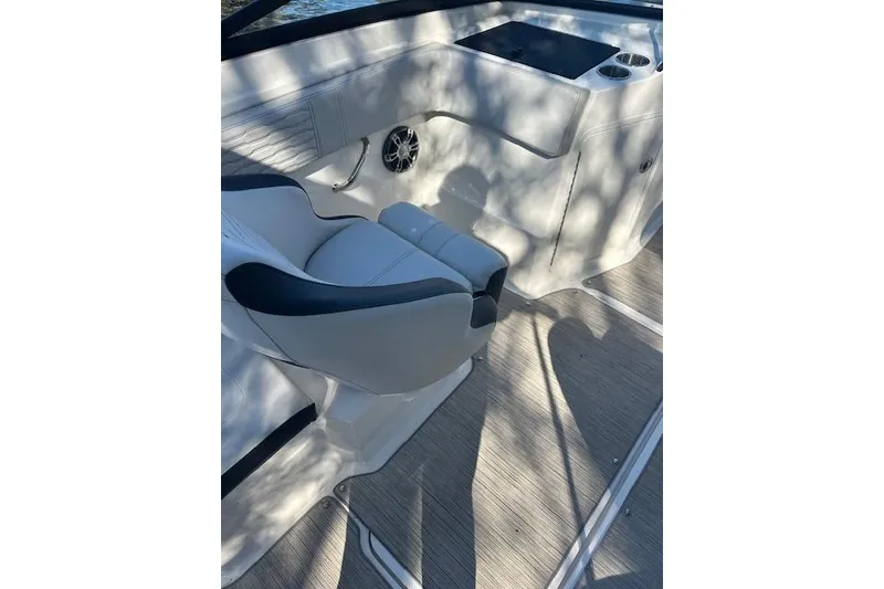 Slide: The Image of 2022 Sea Ray SPX 210 boat interior with white seating and console. - 16