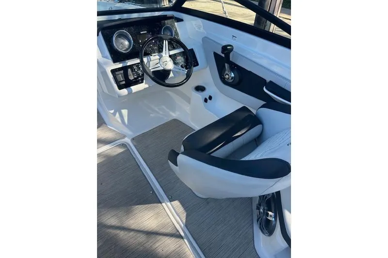 Slide: The Image of 2022 Sea Ray SPX 210 boat interior with steering wheel and seating. - 23