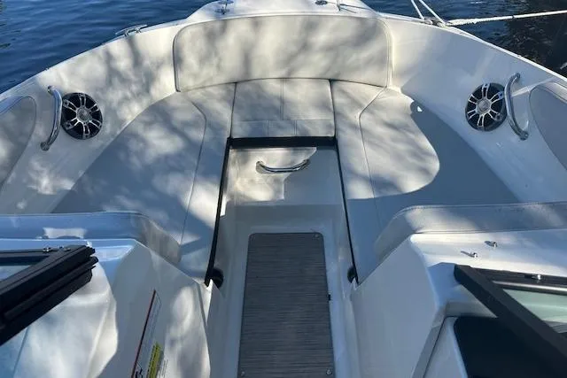 Slide: The Image of 2022 Sea Ray SPX 210 boat interior with seating and speakers on a sunny day. - 29