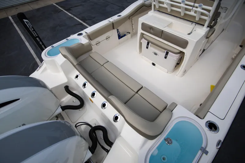 Slide: The Image of 2023 Key West 263 FS boat interior with seating, storage, and twin engines. - 10