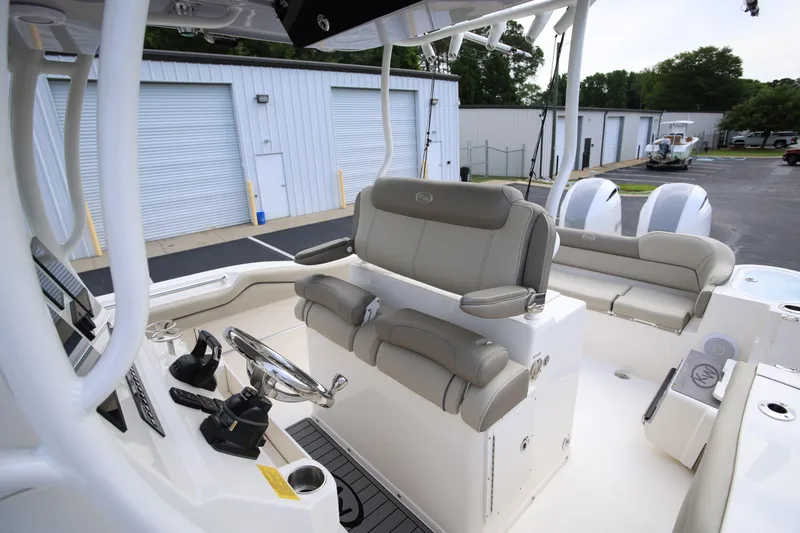 Slide: The Image of 2023 Key West 263 FS boat interior with helm, seating, and storage compartments. - 17