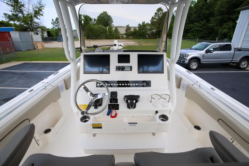 Slide: The Image of 2023 Key West 263 FS boat dashboard with dual screens and steering wheel. - 18