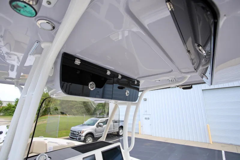 Slide: The Image of 2023 Key West 263 FS boat interior with overhead storage compartments and modern design. - 19