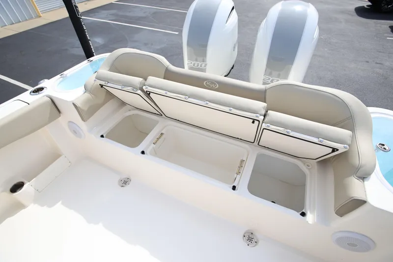 Slide: The Image of 2023 Key West 263 FS boat with open storage compartments and dual engines. - 31