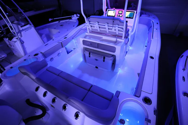Slide: The Image of 2023 Key West 263 FS boat interior with blue LED lighting and modern dashboard. - 33