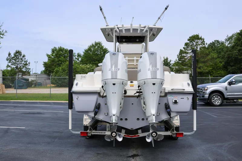 Slide: The Image of 2023 Key West 263 FS boat with dual Yamaha 200 engines, parked outdoors. - 5