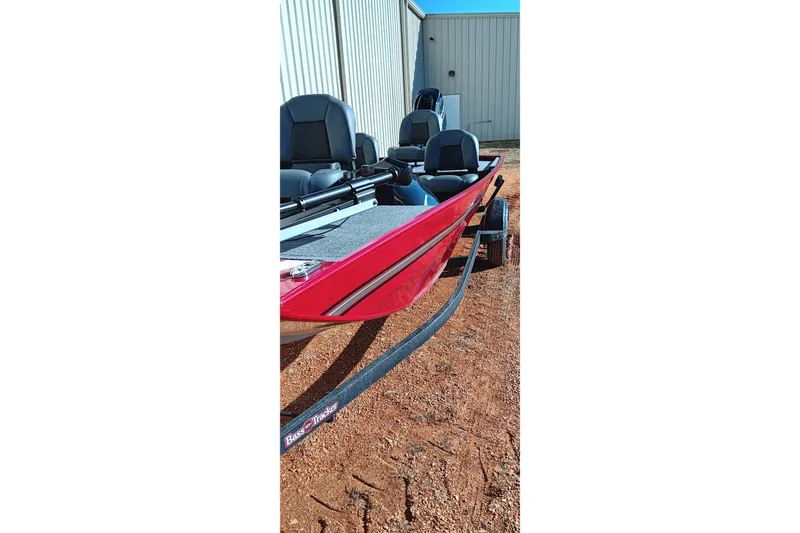 Slide: The Image of 2026 Tracker Bass Tracker Classic XL boat, red exterior, parked on gravel near a building. - 12