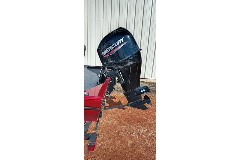Slide: The Image of 2026 Tracker Bass Tracker Classic XL with Mercury outboard motor, parked on red dirt. - 15