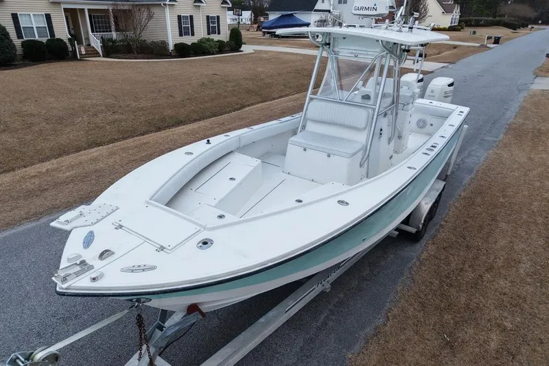 Slide: The Image of 2003 Regulator 26 Forward Seating boat on trailer in suburban neighborhood. - 18