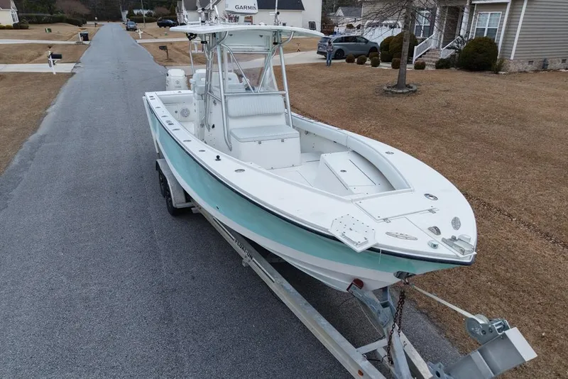 Slide: The Image of 2003 Regulator 26 Forward Seating boat on trailer in suburban neighborhood. - 20