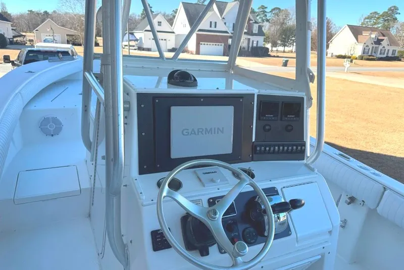 Slide: The Image of 2003 Regulator 26 Forward Seating boat with Garmin navigation system and steering wheel. - 22