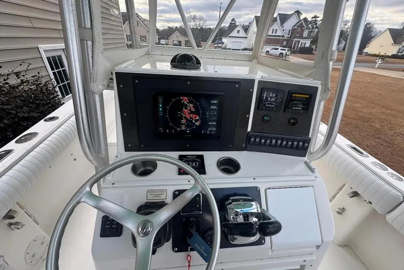 Slide: The Image of 2003 Regulator 26 Forward Seating boat dashboard with navigation and control systems. - 29