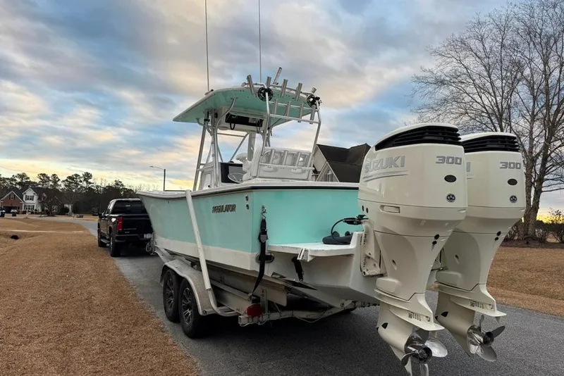 Slide: The Image of 2003 Regulator 26 Forward Seating boat with twin Suzuki 300 engines on a trailer. - 3