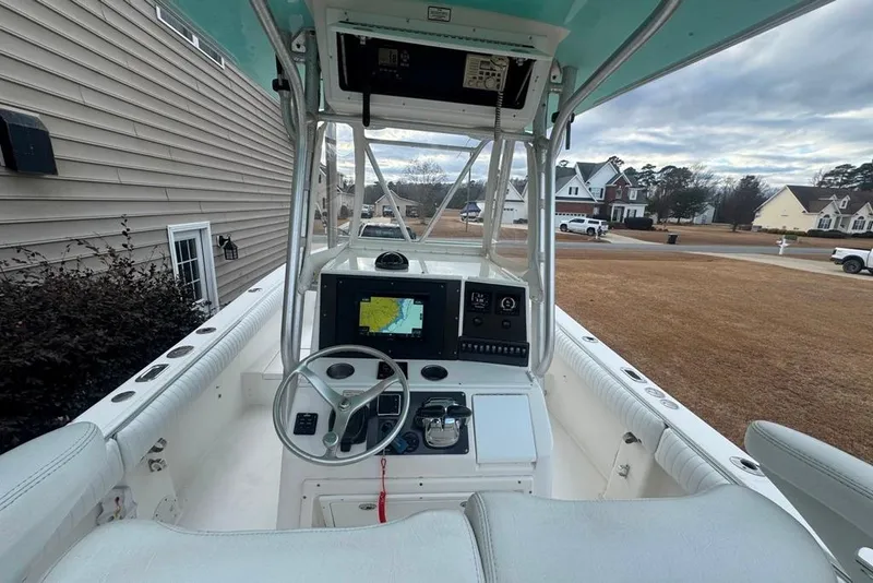 Slide: The Image of 2003 Regulator 26 Forward Seating boat interior with navigation system and steering wheel. - 30