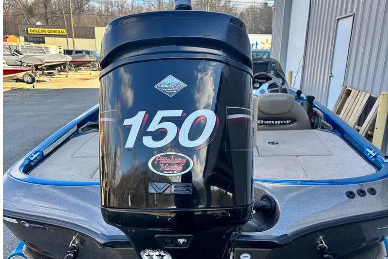 Slide: The Image of 2005 Ranger 185 VX boat with 150 HP outboard motor in a marina setting. - 12