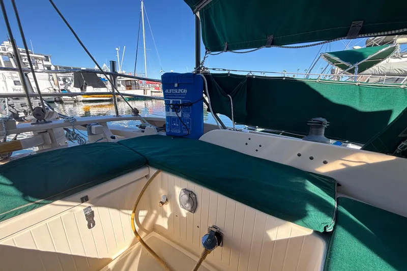 Slide: The Image of 1983 Bristol Channel Cutter 28 sailboat interior with green upholstery at a marina. - 13