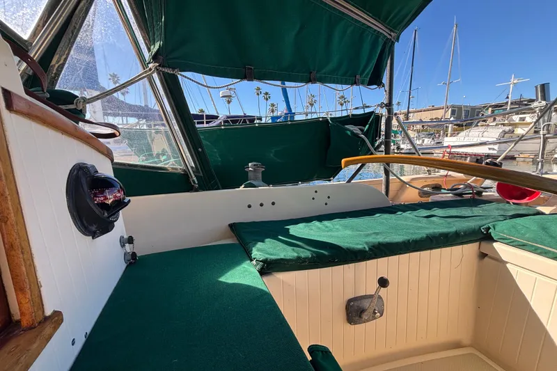 Slide: The Image of 1983 Bristol Channel Cutter 28 cockpit with green canopy, docked in a marina. - 14