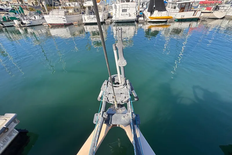 Slide: The Image of Bristol Channel Cutter 28 sailboat bow in marina, 1983 model, calm water reflections. - 22