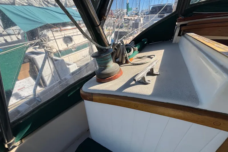 Slide: The Image of 1983 Bristol Channel Cutter 28 sailboat deck with winch and cleat in marina. - 23