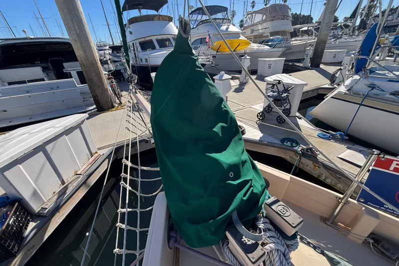 Slide: The Image of Bristol Channel Cutter 28 sailboat docked at marina, covered sail, 1983 model. - 27