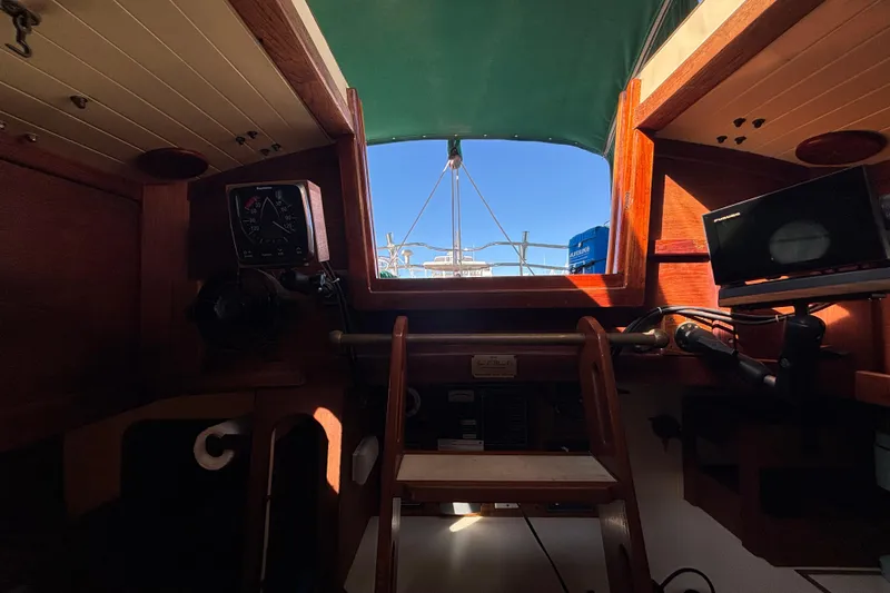 Slide: The Image of Interior view of 1983 Bristol Channel Cutter 28 sailboat cockpit with navigation instruments. - 29