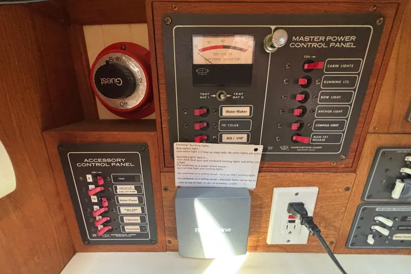 Slide: The Image of Control panels on a 1983 Bristol Channel Cutter 28, featuring switches and battery monitor. - 32