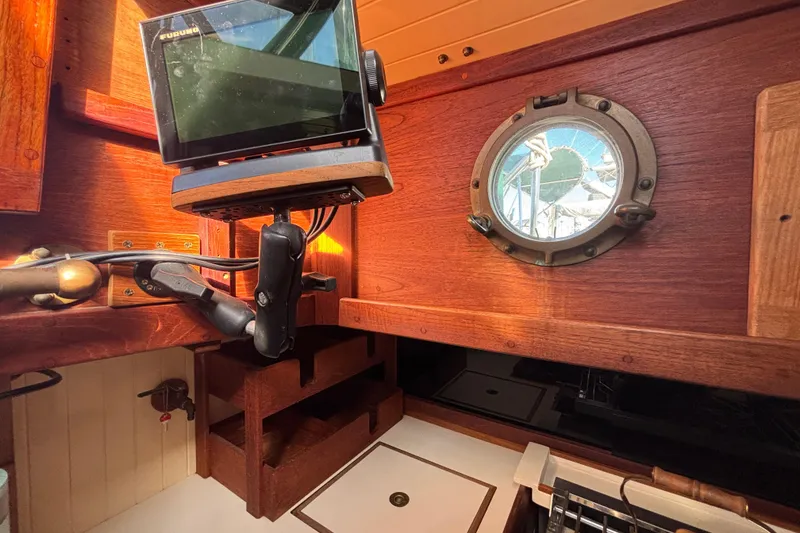 Slide: The Image of Interior of 1983 Bristol Channel Cutter 28 with navigation equipment and porthole view. - 34