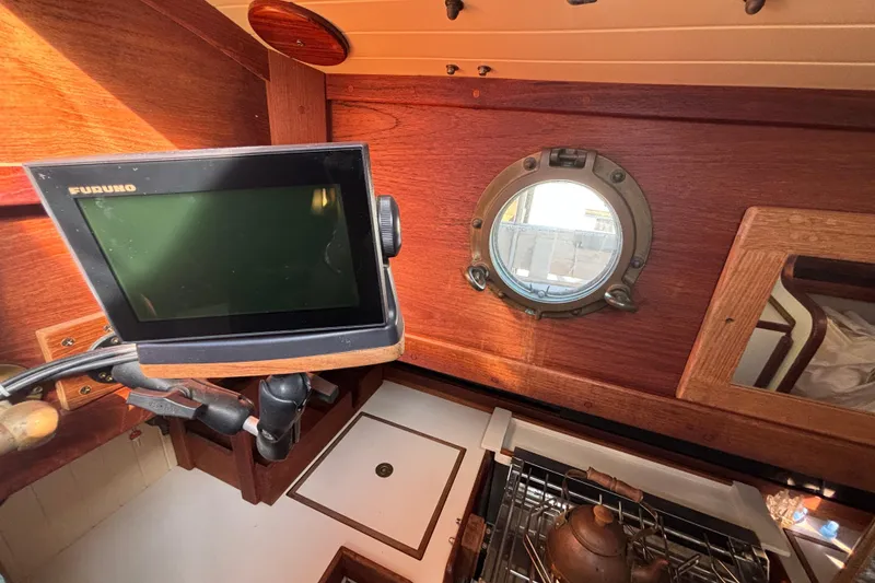 Slide: The Image of Interior of a 1983 Bristol Channel Cutter 28 with navigation equipment and porthole. - 35